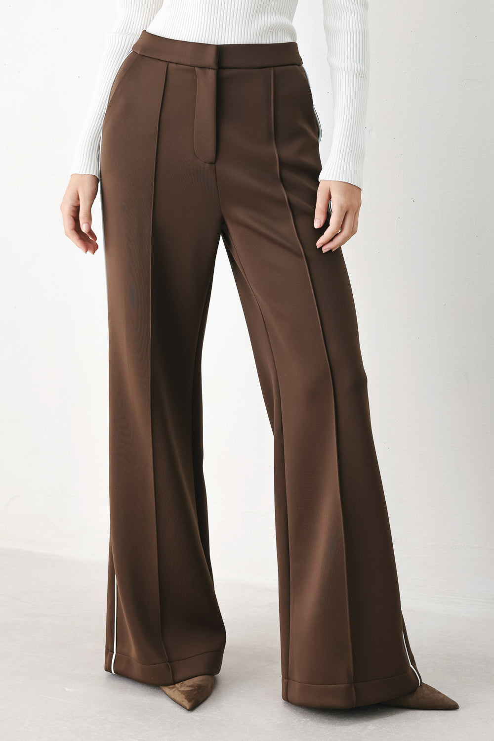 Model wearing brown wide-leg trousers with white side stripes | FREEMARKET