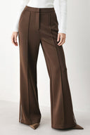 Model wearing brown wide-leg trousers with white side stripes | FREEMARKET
