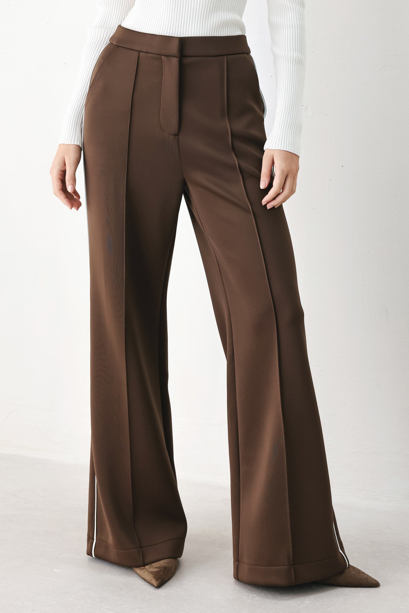 Model wearing brown wide-leg trousers with white side stripes | FREEMARKET