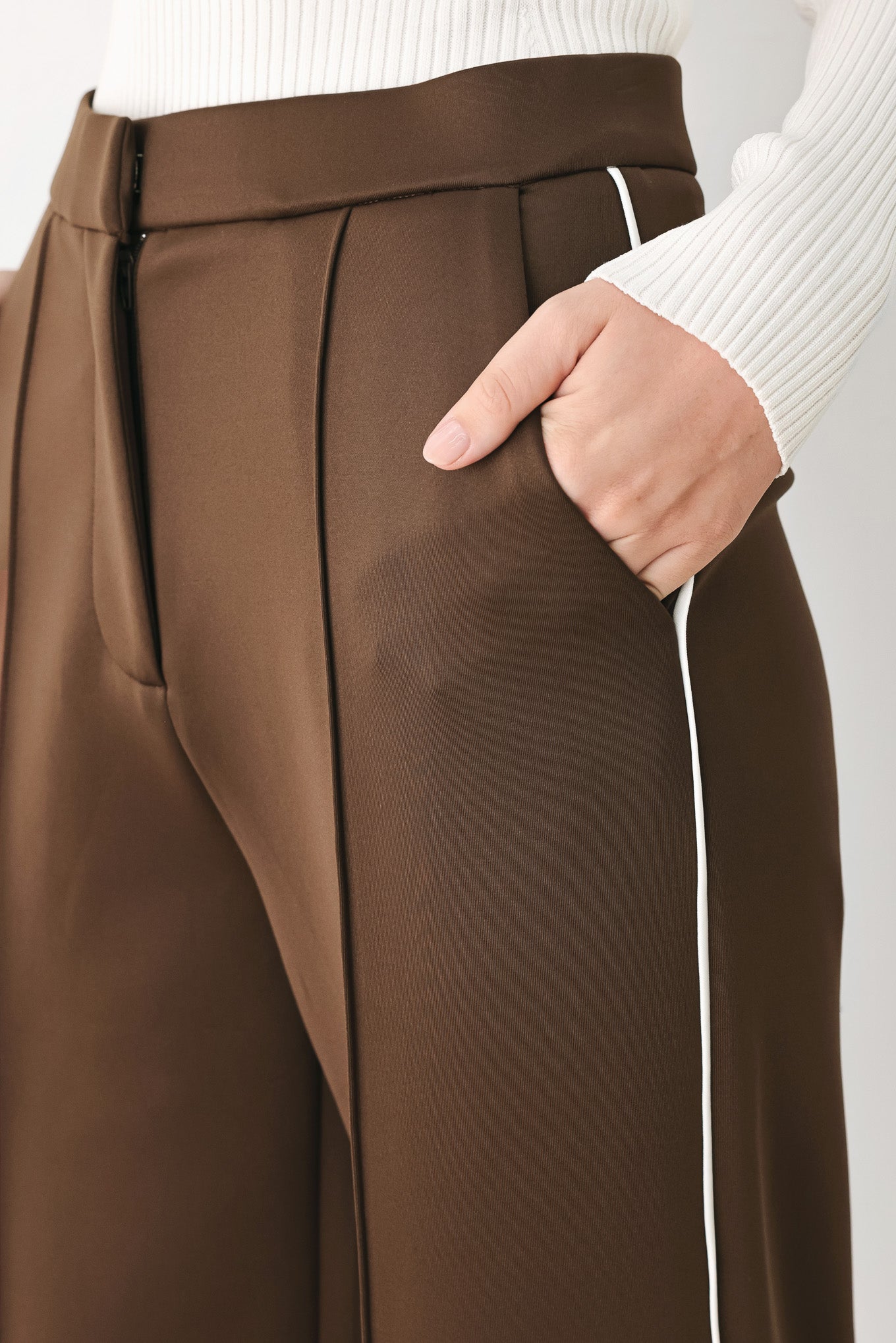 Model wearing brown wide-leg trousers with white side stripes | FREEMARKET