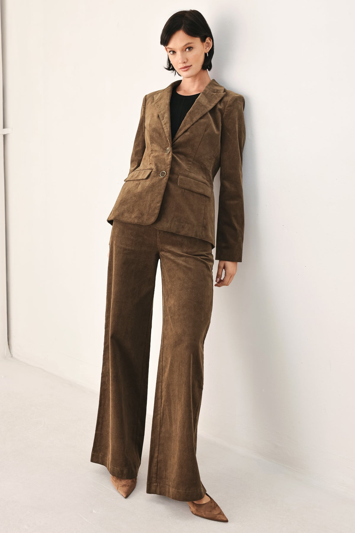 A model wearing high-waisted, wide-leg brown corduroy pants with a drawstring waist | FREEMARKET