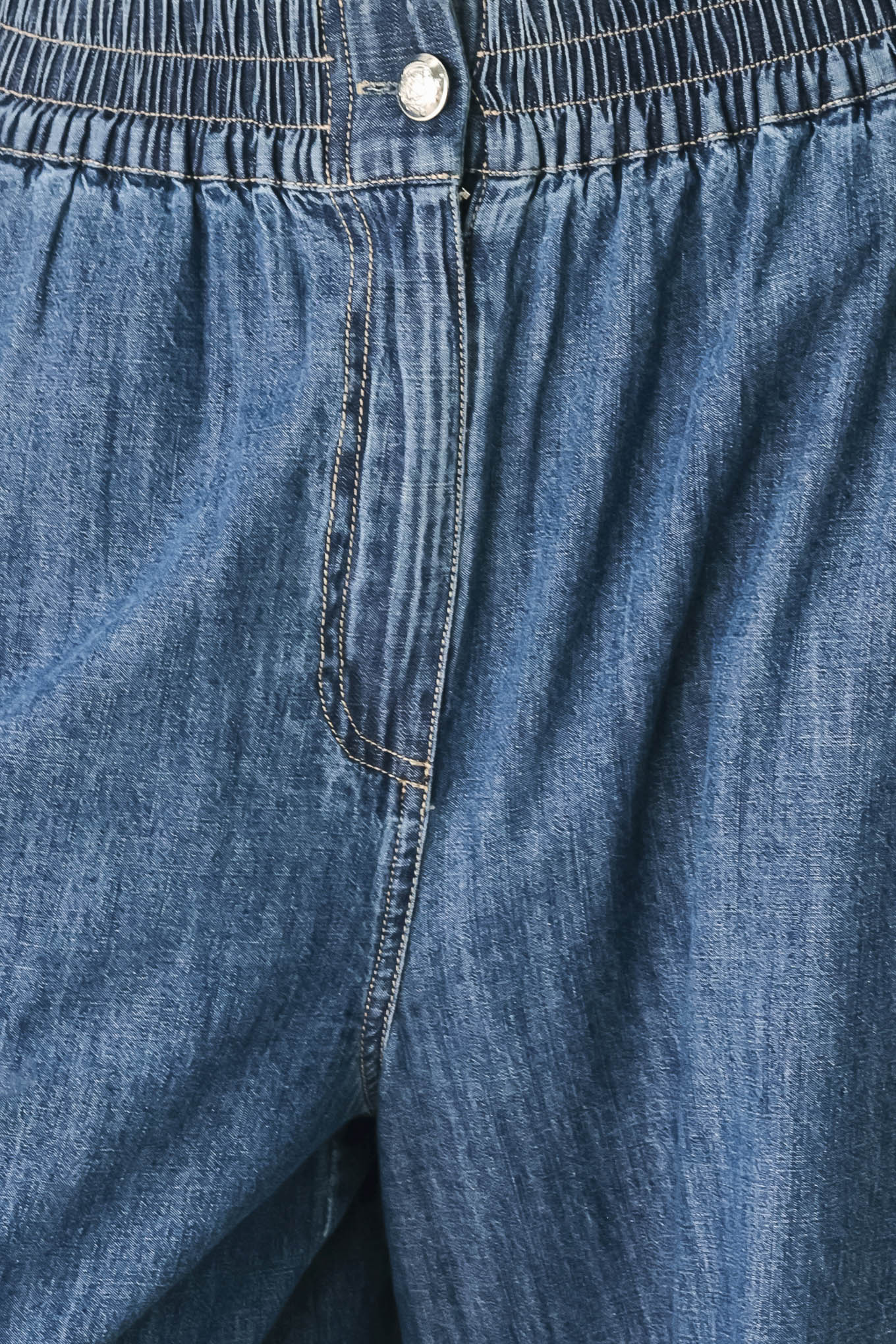 A person wearing wide-leg blue denim jeans with an elastic waistband, side pockets, and a button closure | FREEMARKET