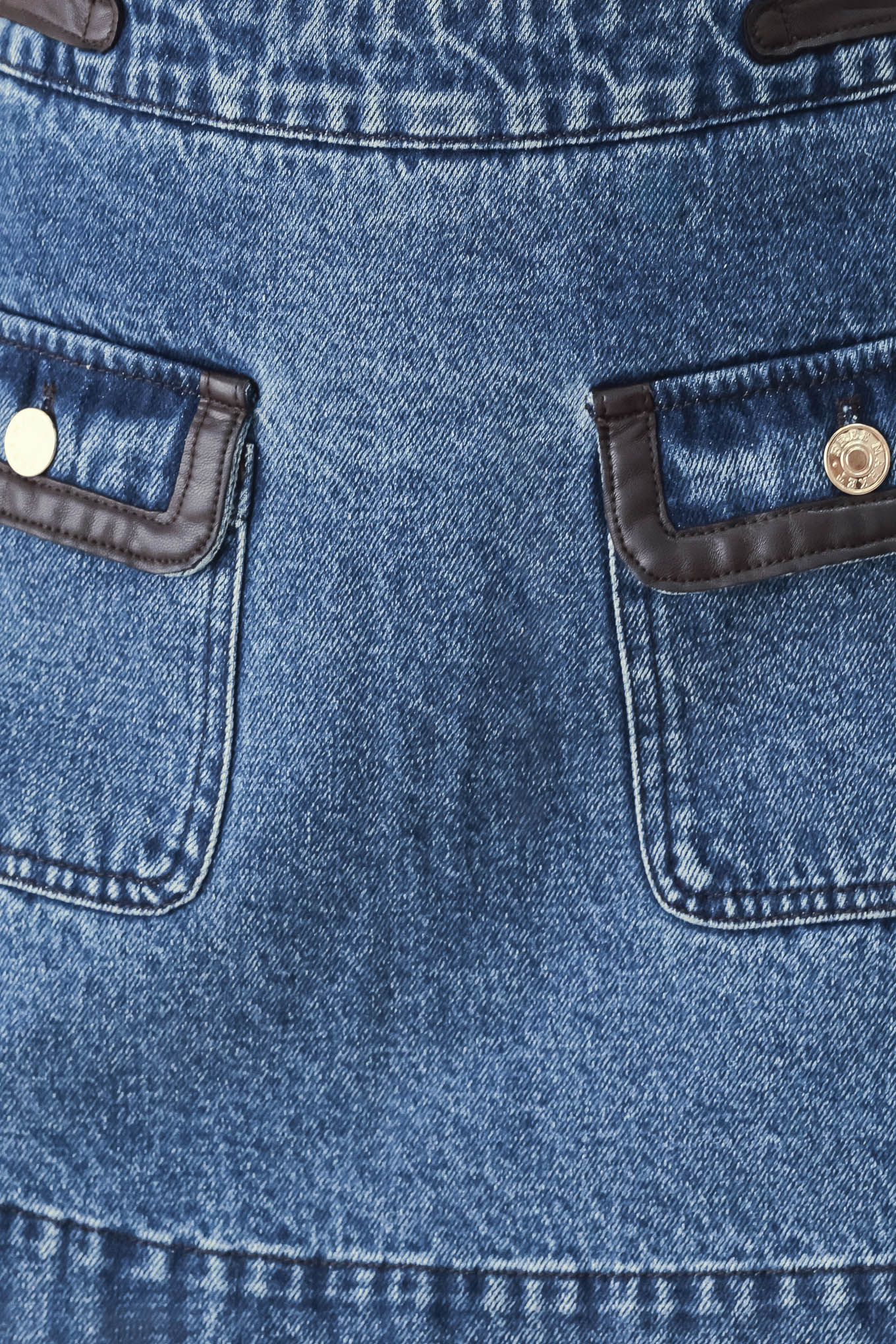 A model wearing a blue denim mini skort with dark brown leather accents on the waistband and pocket flaps | FREEMARKET