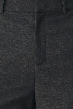 Woman wearing black high waisted pants with gold button details around the side calf | FREEMARKET