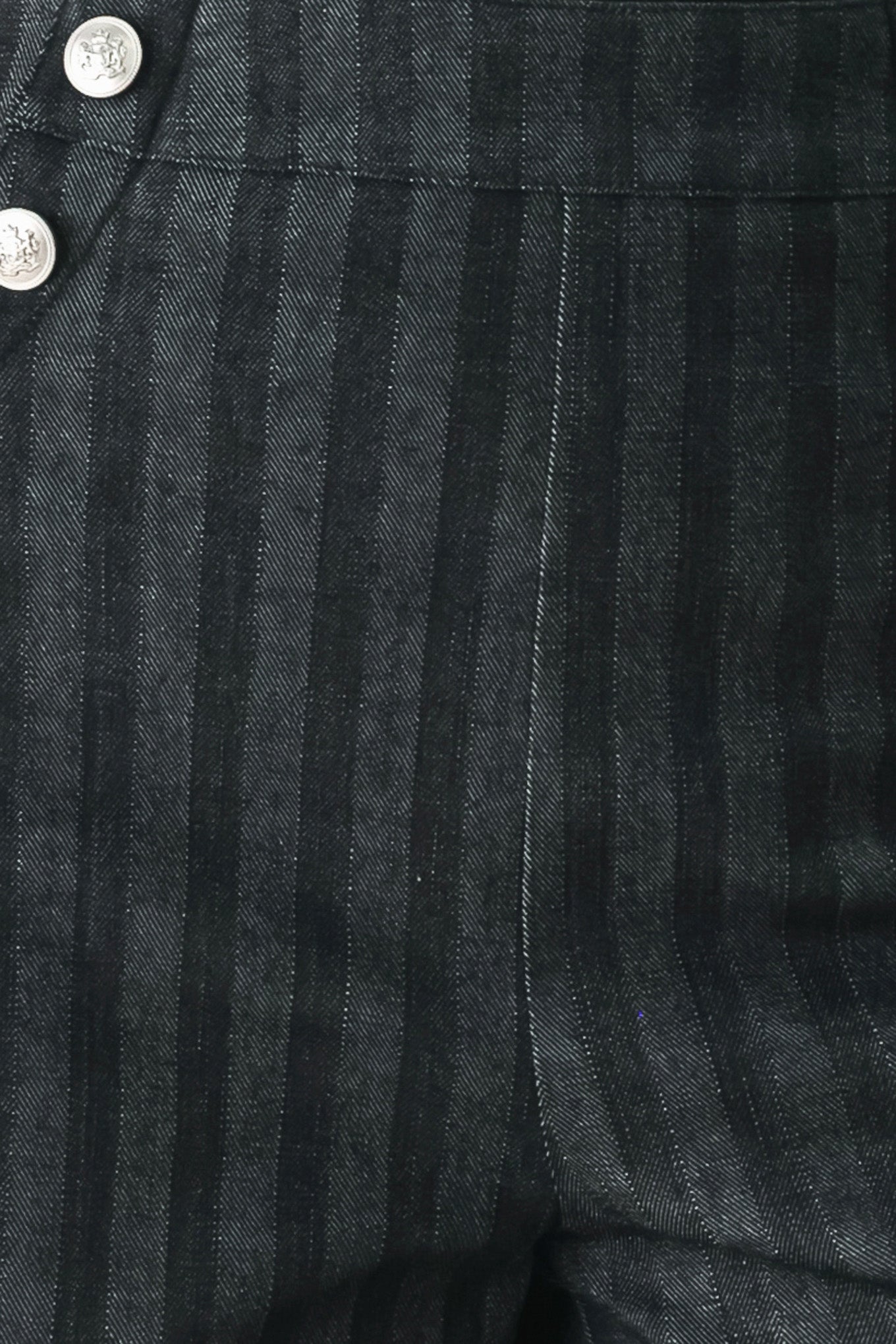 A model wearing a pair of high-waisted, wide-leg trousers in a dark gray and black pinstripe pattern, featuring decorative silver buttons on the front waistband | FREEMARKET