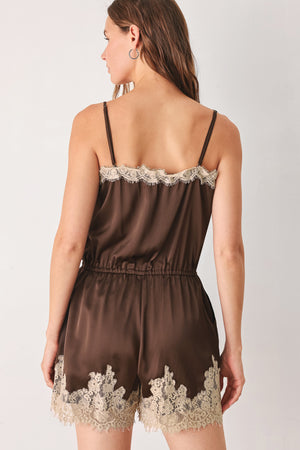 A woman wearing a brown satin romper with beige lace trim at the neckline | FREEMARKET