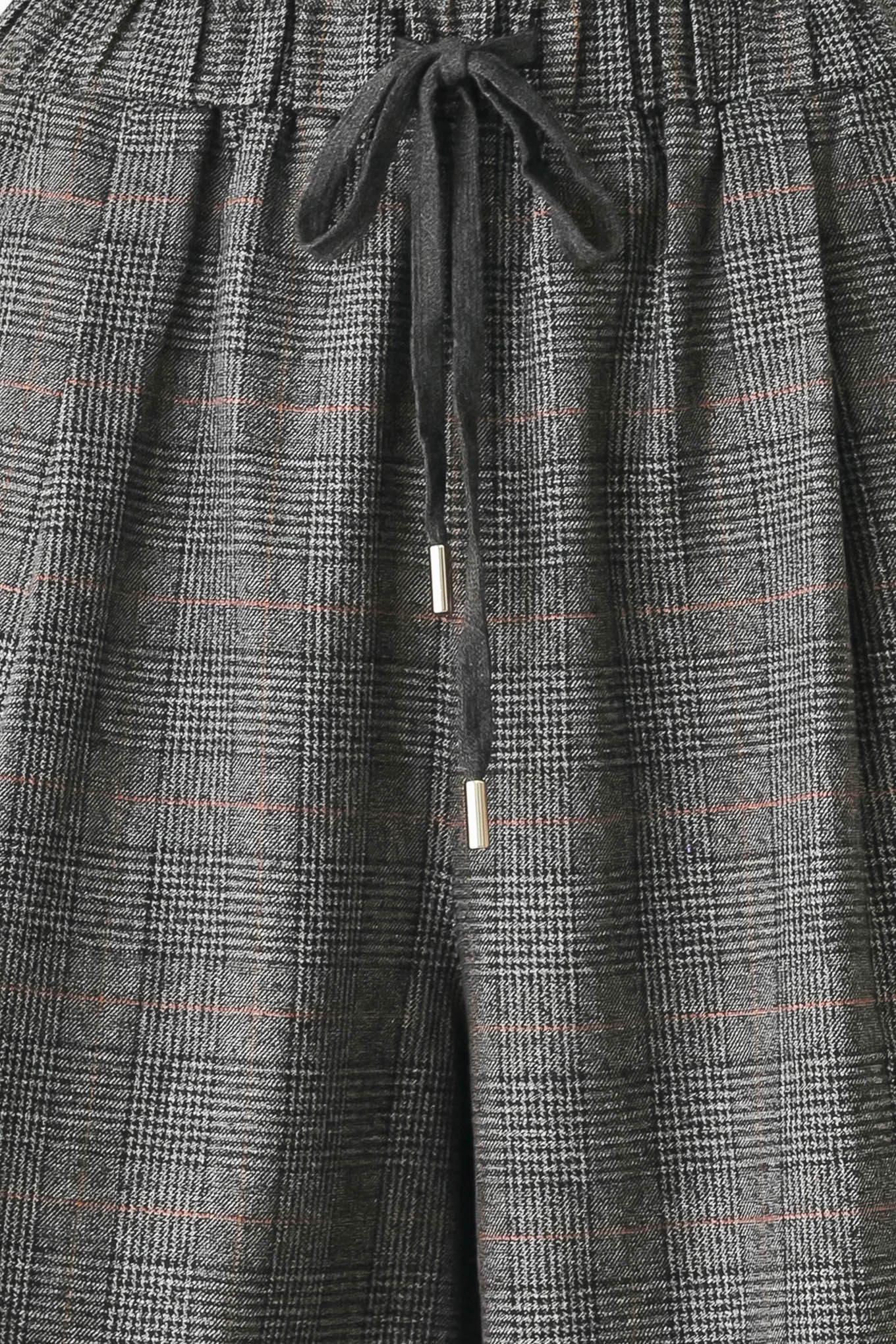 A person wearing loose, wide-leg plaid trousers in dark gray with subtle brown and beige lines, featuring an elastic drawstring waistband | FREEMARKET
