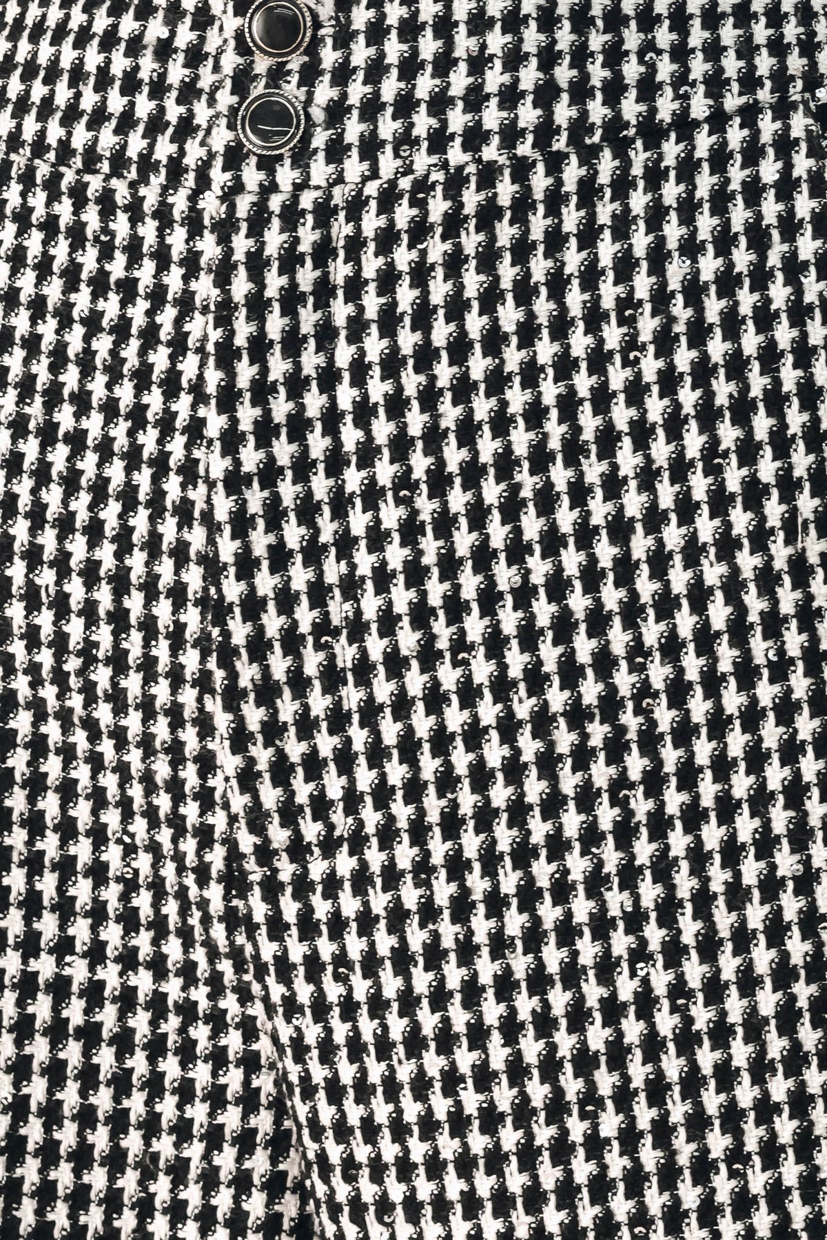 A person wearing high-waisted, wide-leg trousers with a black and white houndstooth pattern | FREEMARKET
