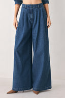A woman wearing high-waisted, wide-leg blue denim pants with a wide-leg fit | FREEMARKET