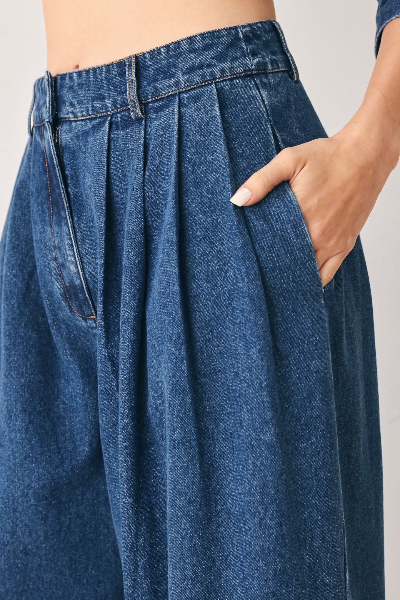 A woman wearing high-waisted, wide-leg blue denim pants with a wide-leg fit | FREEMARKET