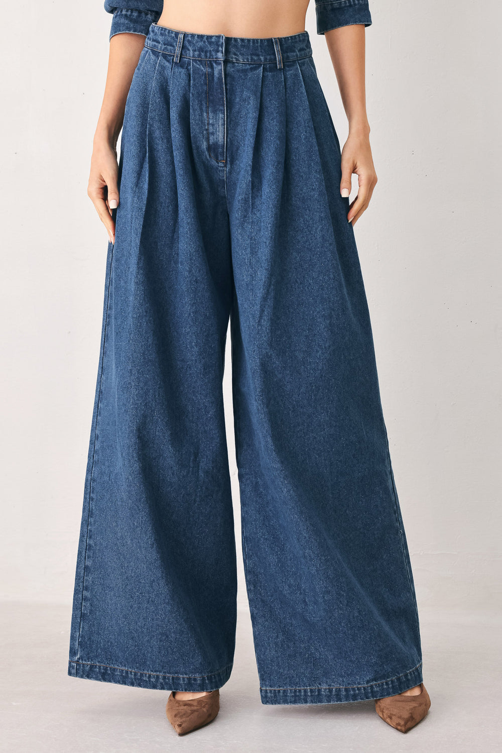 A woman wearing high-waisted, wide-leg blue denim pants with a wide-leg fit | FREEMARKET