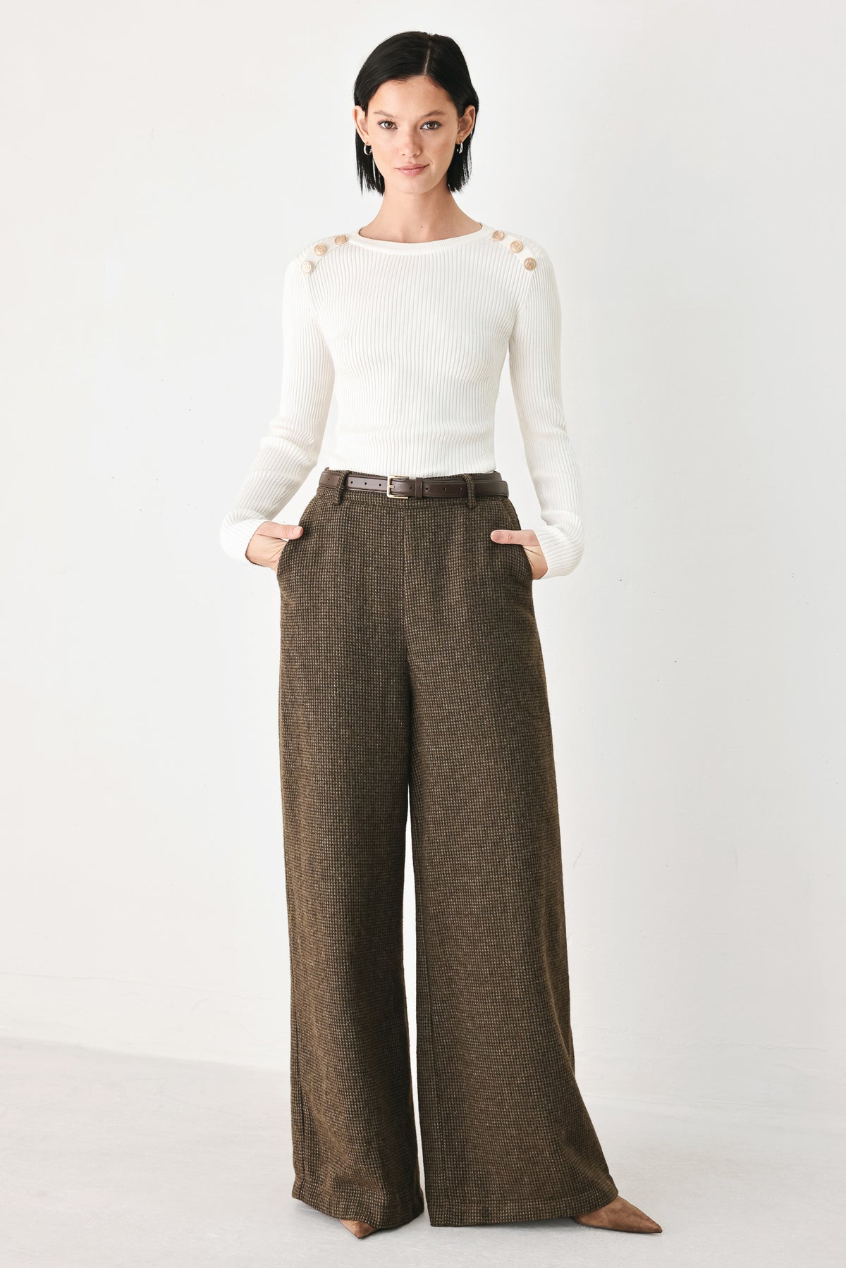 A person wearing high-waisted, wide-leg brown houndstooth trousers with a matching brown belt | FREEMARKET