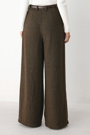A person wearing high-waisted, wide-leg brown houndstooth trousers with a matching brown belt | FREEMARKET