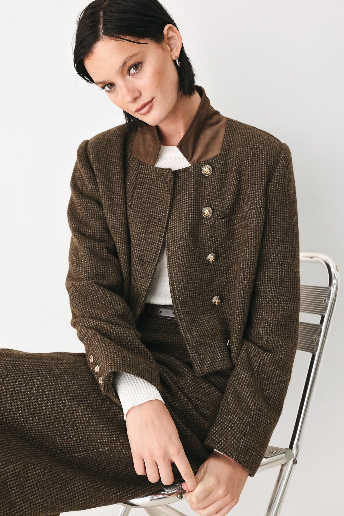 A person wearing high-waisted, wide-leg brown houndstooth trousers with a matching brown belt | FREEMARKET