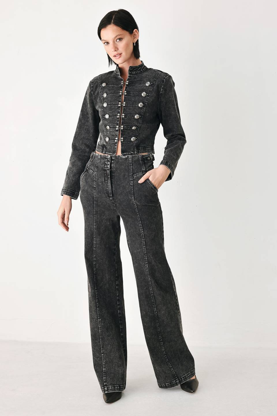 A pair of high-waisted, wide-leg jeans in a washed black or charcoal gray denim, shown on a model | FREEMARKET