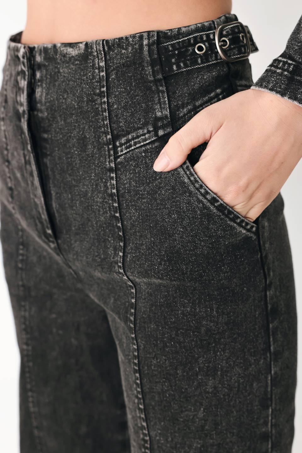 A pair of high-waisted, wide-leg jeans in a washed black or charcoal gray denim, shown on a model | FREEMARKET