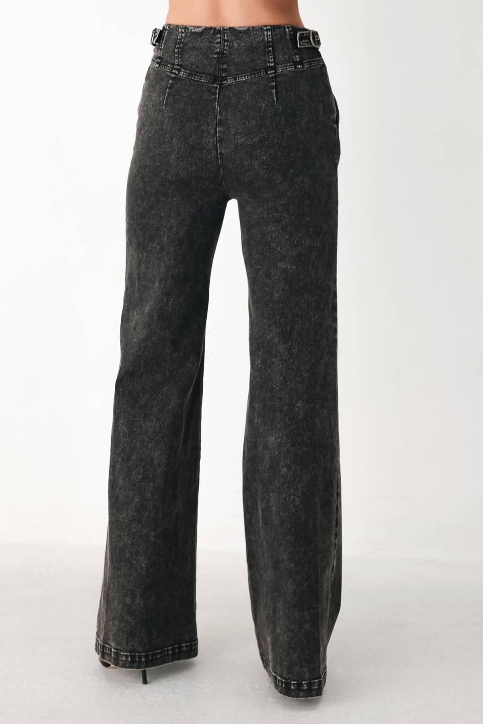 A pair of high-waisted, wide-leg jeans in a washed black or charcoal gray denim, shown on a model | FREEMARKET