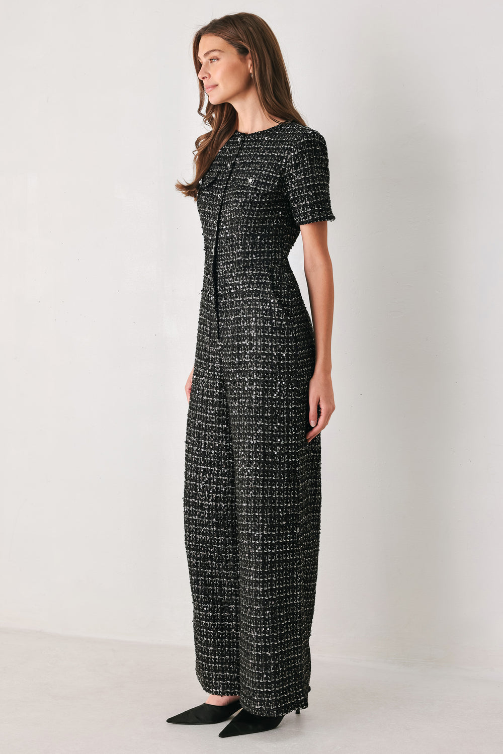 Woman wearing a black houndstooth shot sleeve jumpsuit | FREEMARKET