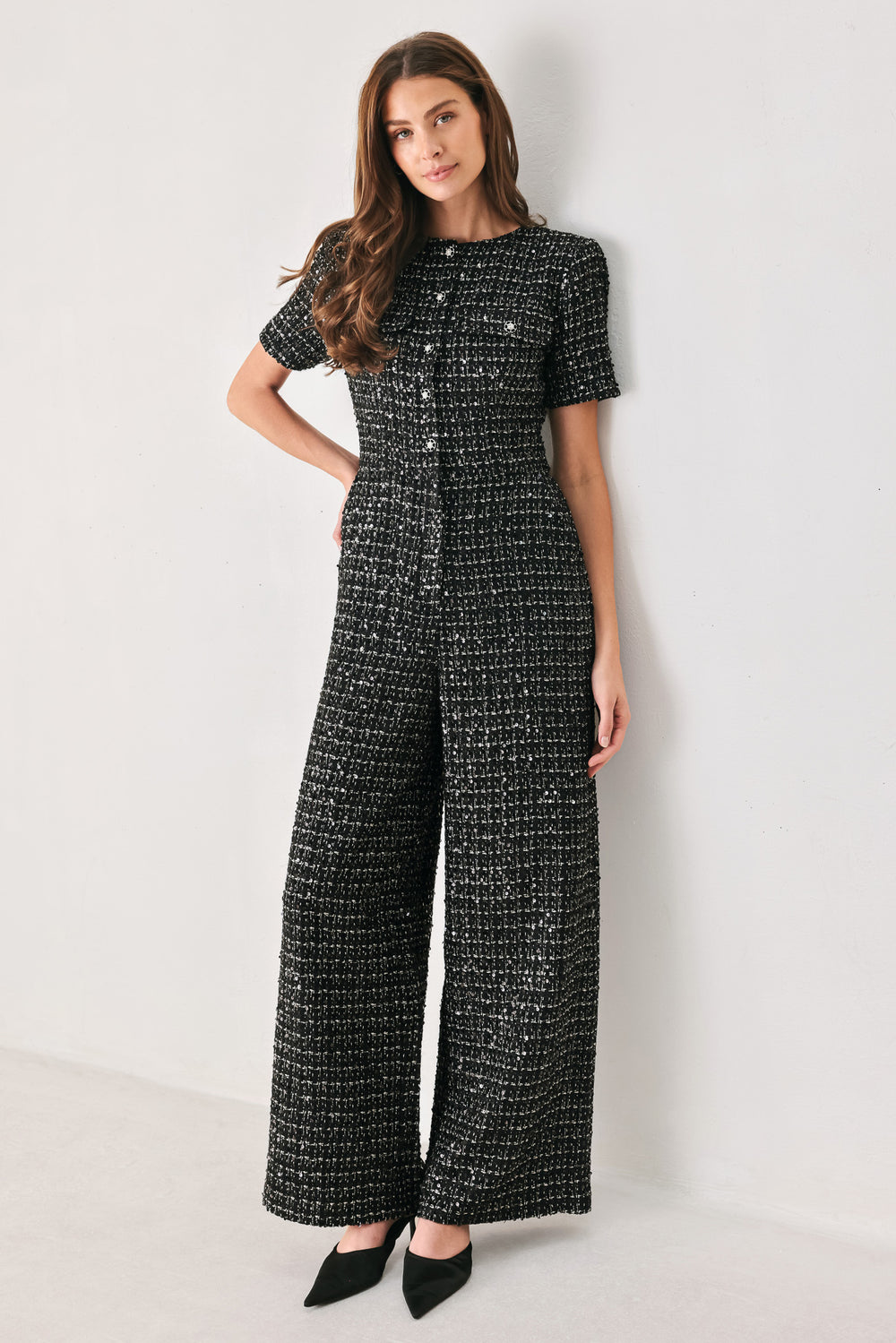 Woman wearing a black houndstooth shot sleeve jumpsuit | FREEMARKET