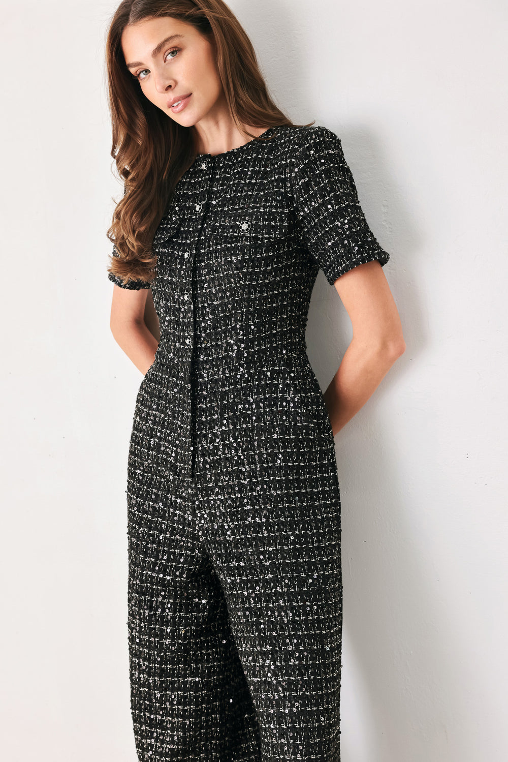 Woman wearing a black houndstooth shot sleeve jumpsuit | FREEMARKET