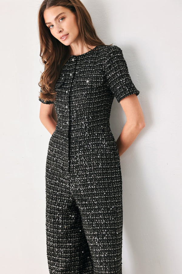 Woman wearing a black houndstooth shot sleeve jumpsuit | FREEMARKET