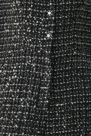 Woman wearing a black houndstooth shot sleeve jumpsuit | FREEMARKET