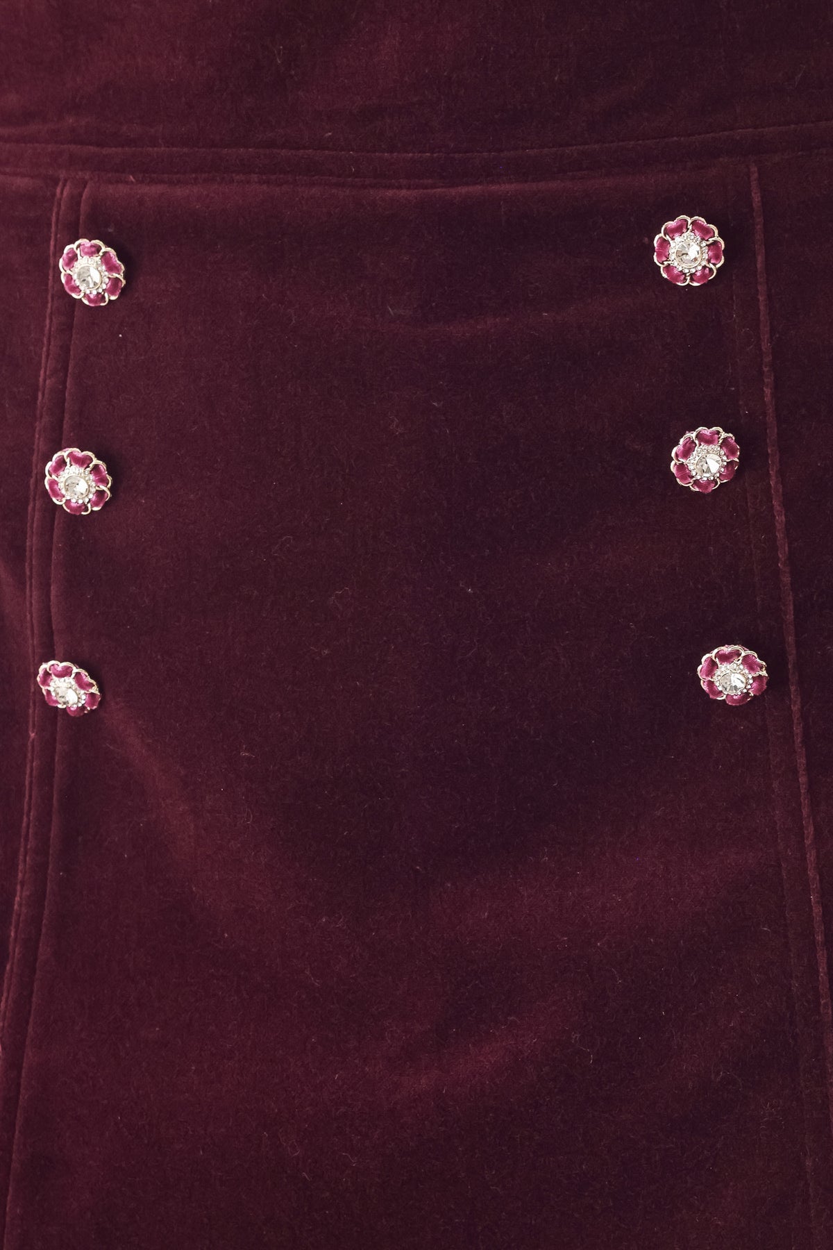 Woman wearing a burgundy velvet skort with buttons | FREEMARKET