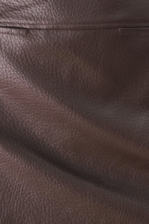 A dark brown faux-leather mini skort with a pebbled texture, worn by a model | FREEMARKET