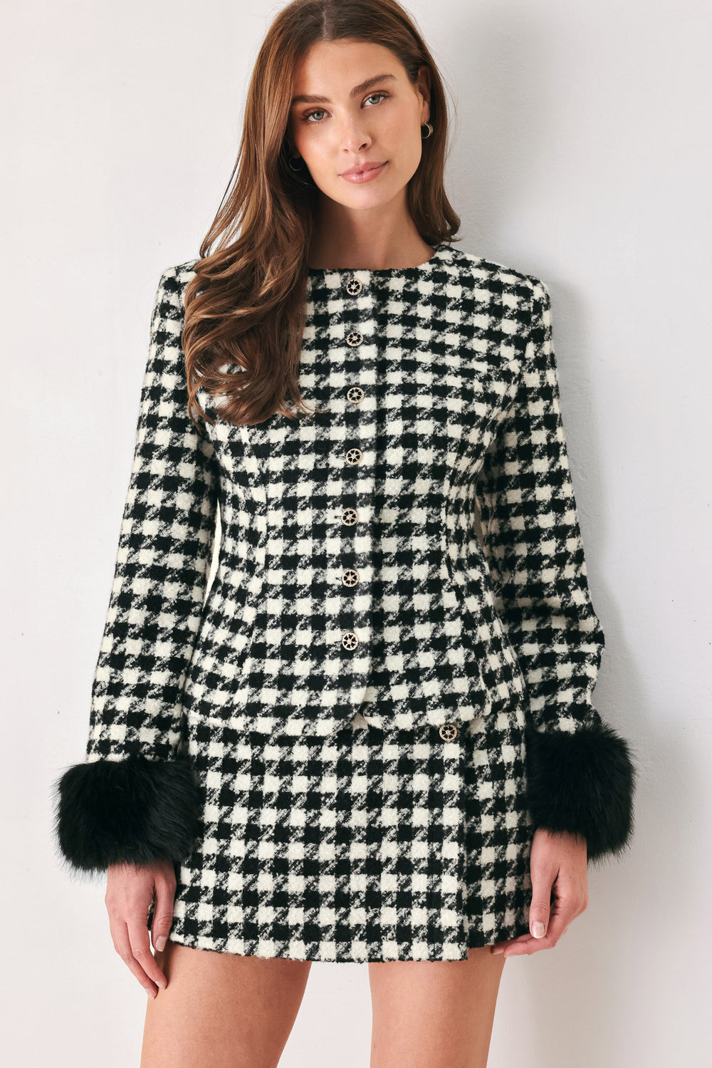 Woman wearing a high waisted black and white houndstooth skort with buttons | FREEMARKET