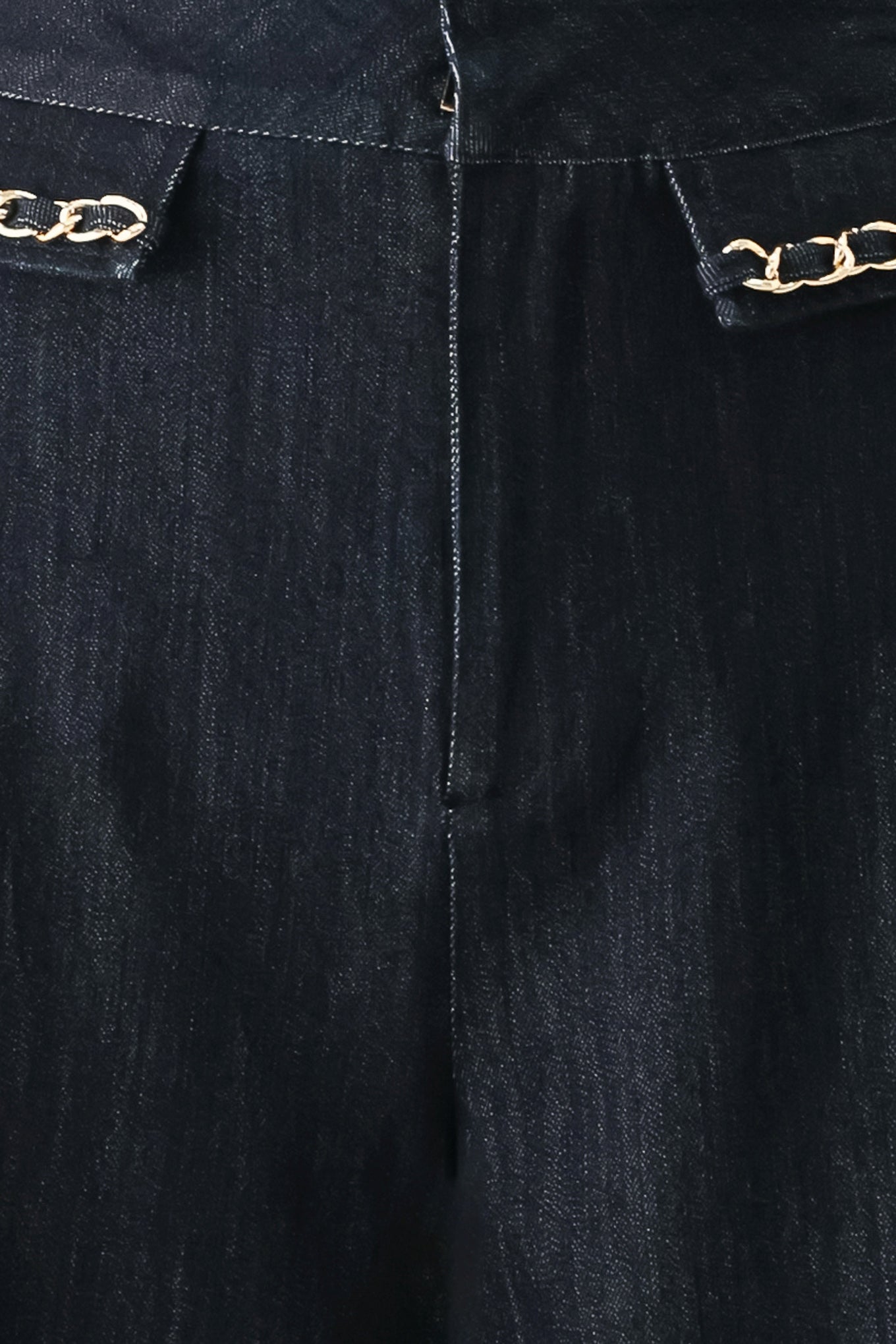 A model wearing dark indigo wide-leg denim jeans with gold chain embellishments on the front pockets | FREEMARKET
