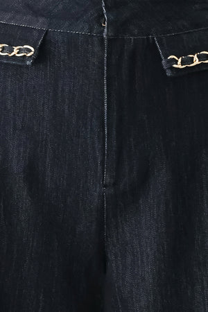 A model wearing dark indigo wide-leg denim jeans with gold chain embellishments on the front pockets | FREEMARKET