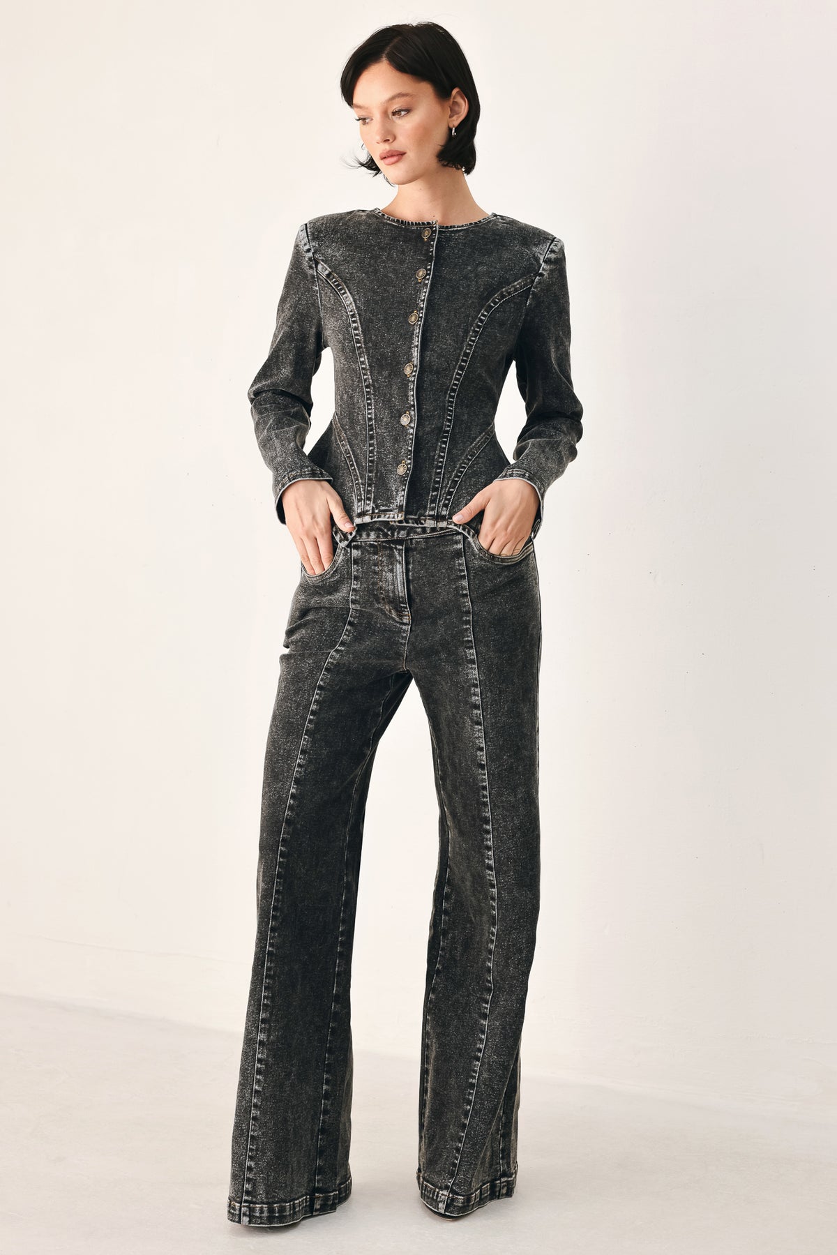 Wide-leg black acid-wash denim jeans with a high waist and studded belt loops, shown on a model | FREEMARKET
