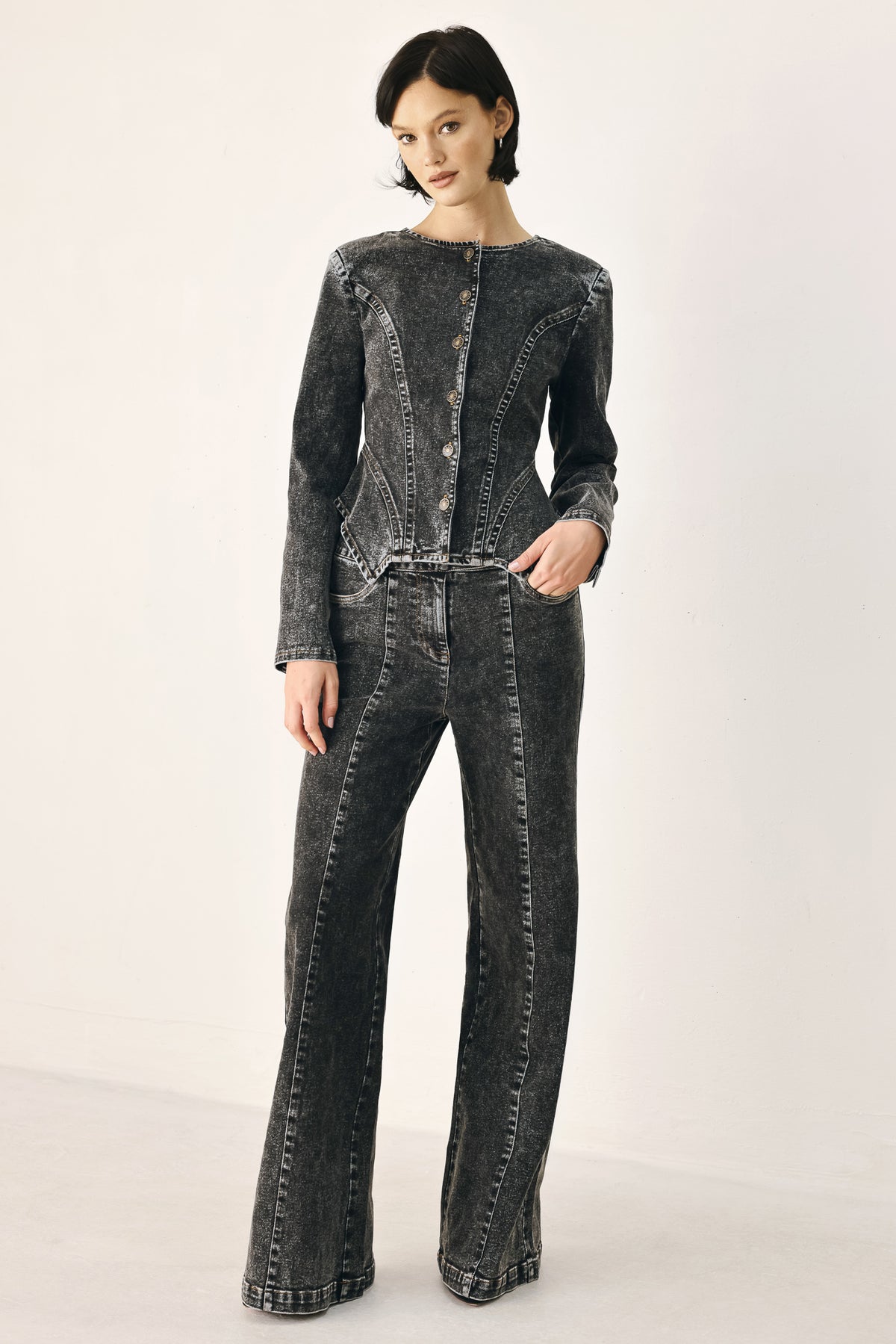 Wide-leg black acid-wash denim jeans with a high waist and studded belt loops, shown on a model | FREEMARKET