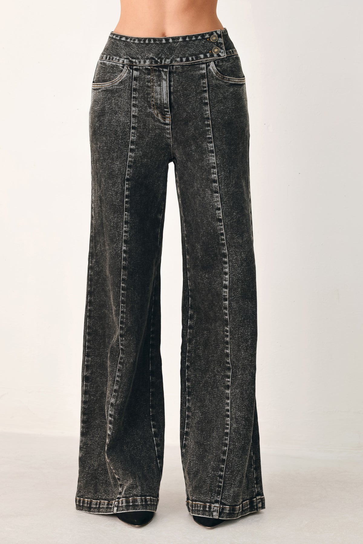 Wide-leg black acid-wash denim jeans with a high waist and studded belt loops, shown on a model | FREEMARKET