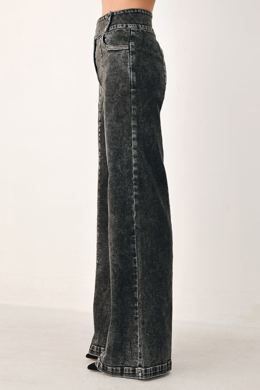 Wide-leg black acid-wash denim jeans with a high waist and studded belt loops, shown on a model | FREEMARKET