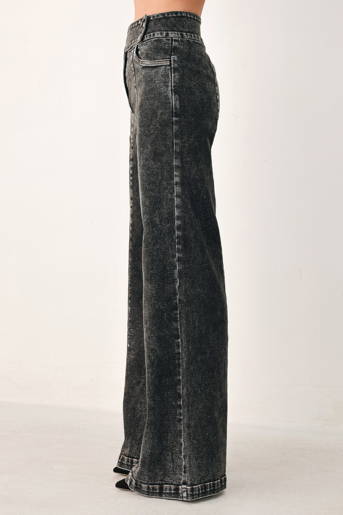 Wide-leg black acid-wash denim jeans with a high waist and studded belt loops, shown on a model | FREEMARKET
