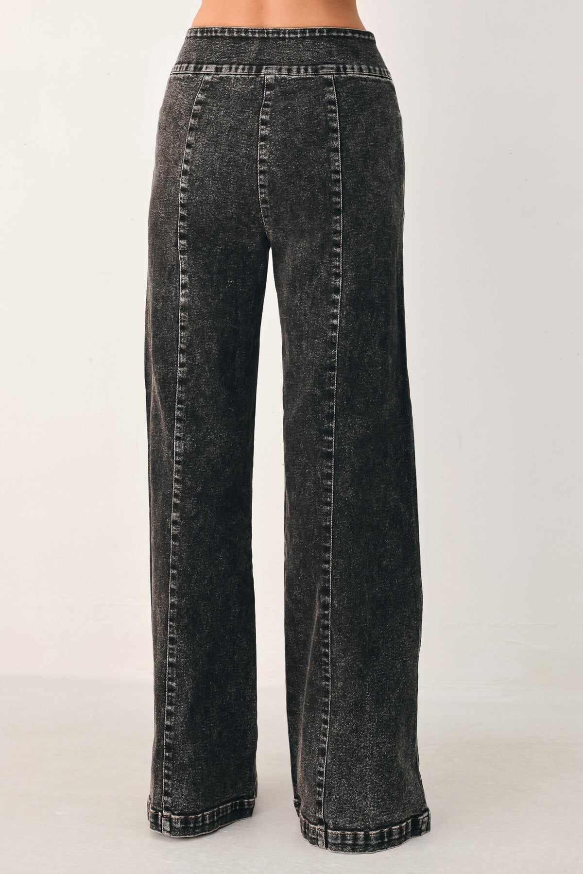 Wide-leg black acid-wash denim jeans with a high waist and studded belt loops, shown on a model | FREEMARKET