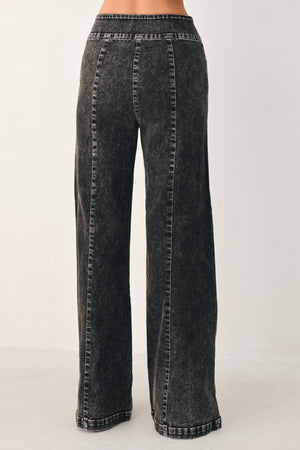 Wide-leg black acid-wash denim jeans with a high waist and studded belt loops, shown on a model | FREEMARKET