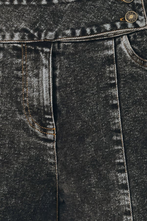 Wide-leg black acid-wash denim jeans with a high waist and studded belt loops, shown on a model | FREEMARKET