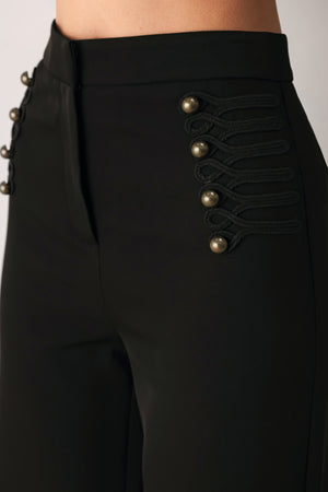 Woman wearing a pair of black high waisted pants with buttons going from the waist to the hips and braiding | FREEMARKET
