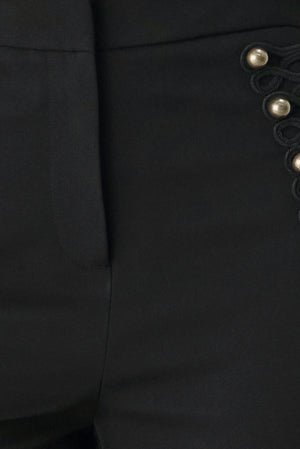 Woman wearing a pair of black high waisted pants with buttons going from the waist to the hips and braiding | FREEMARKET