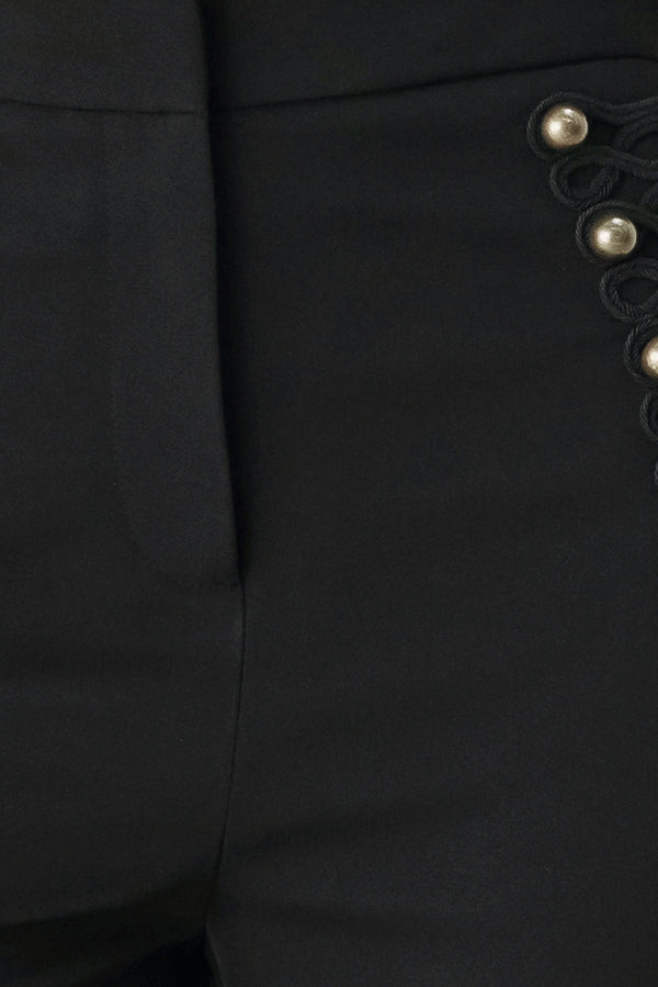 Woman wearing a pair of black high waisted pants with buttons going from the waist to the hips and braiding | FREEMARKET