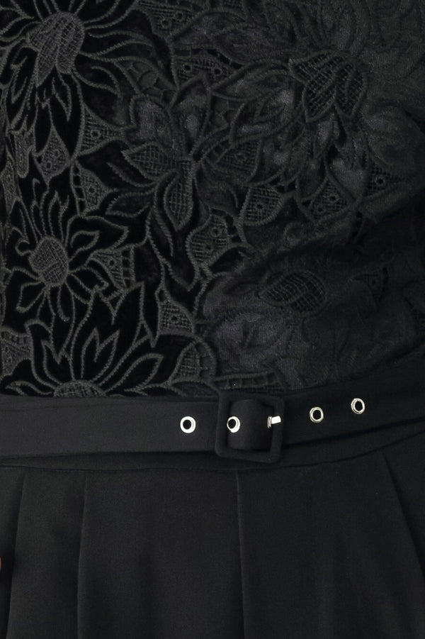 A woman modeling a black long-sleeve jumpsuit with a lace bodice and wide-leg trousers | FREEMARKET