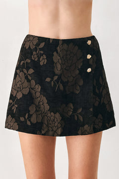 Woman wearing a dark brown mini skort with a brown floral jacquard pattern | FREEMARKET