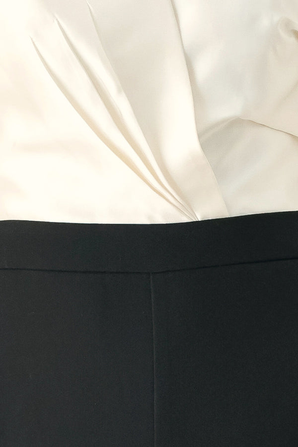 Woman wearing a strapless jumpsuit with white top and black bottom | FREEMARKET