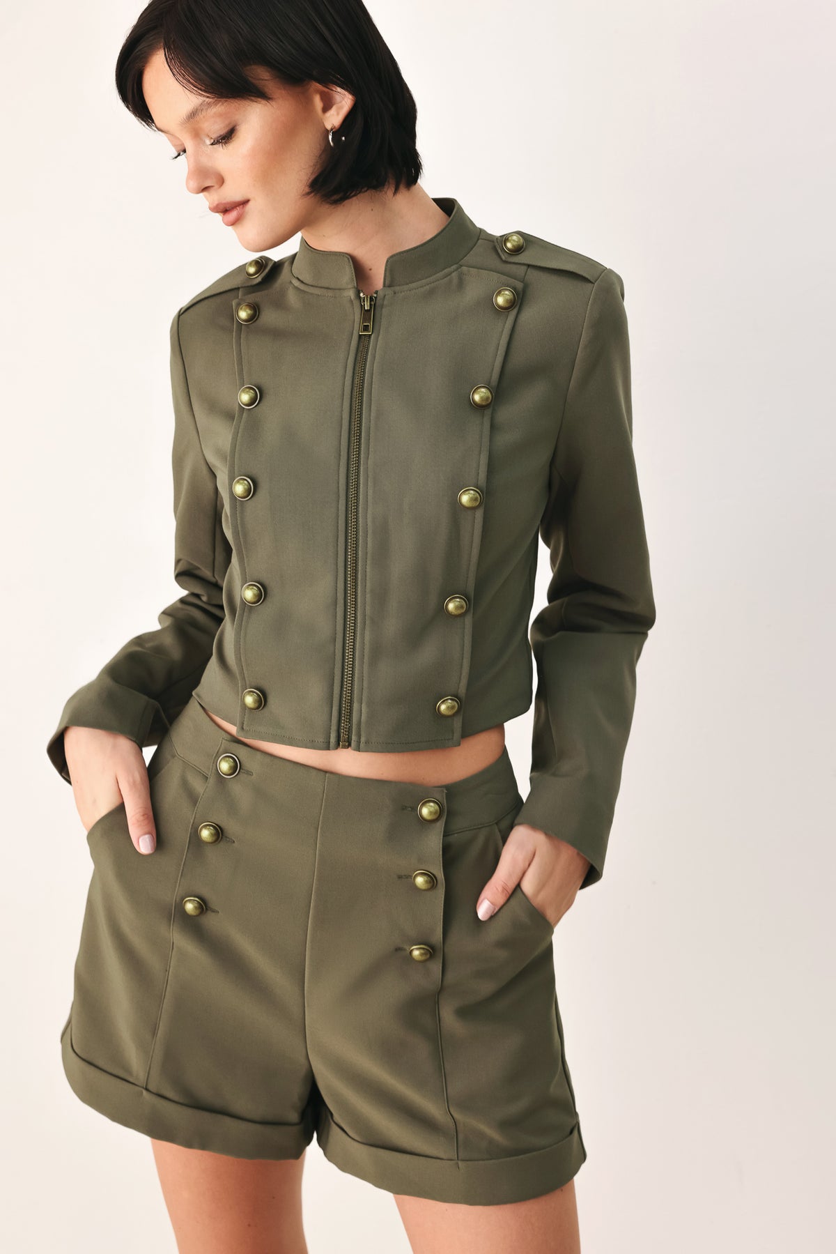 Olive green double-breasted shorts with gold-tone buttons, modeled by a woman | FREEMARKET