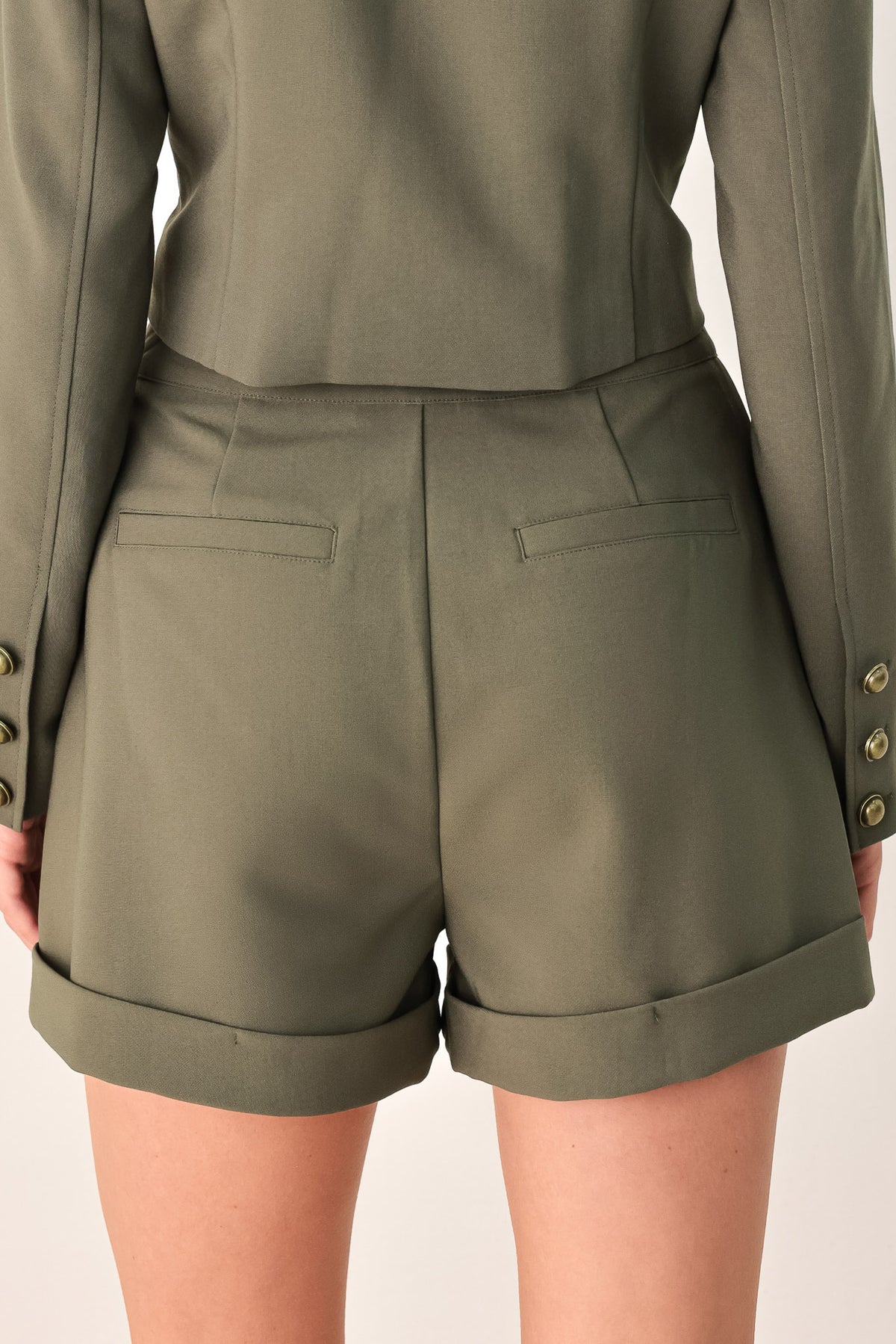 Olive green double-breasted shorts with gold-tone buttons, modeled by a woman | FREEMARKET