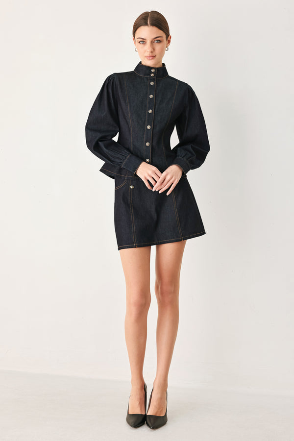 Woman wearing a dark lightweight denim skort with front button detail, pockets and back zipper closure | FREEMARKET