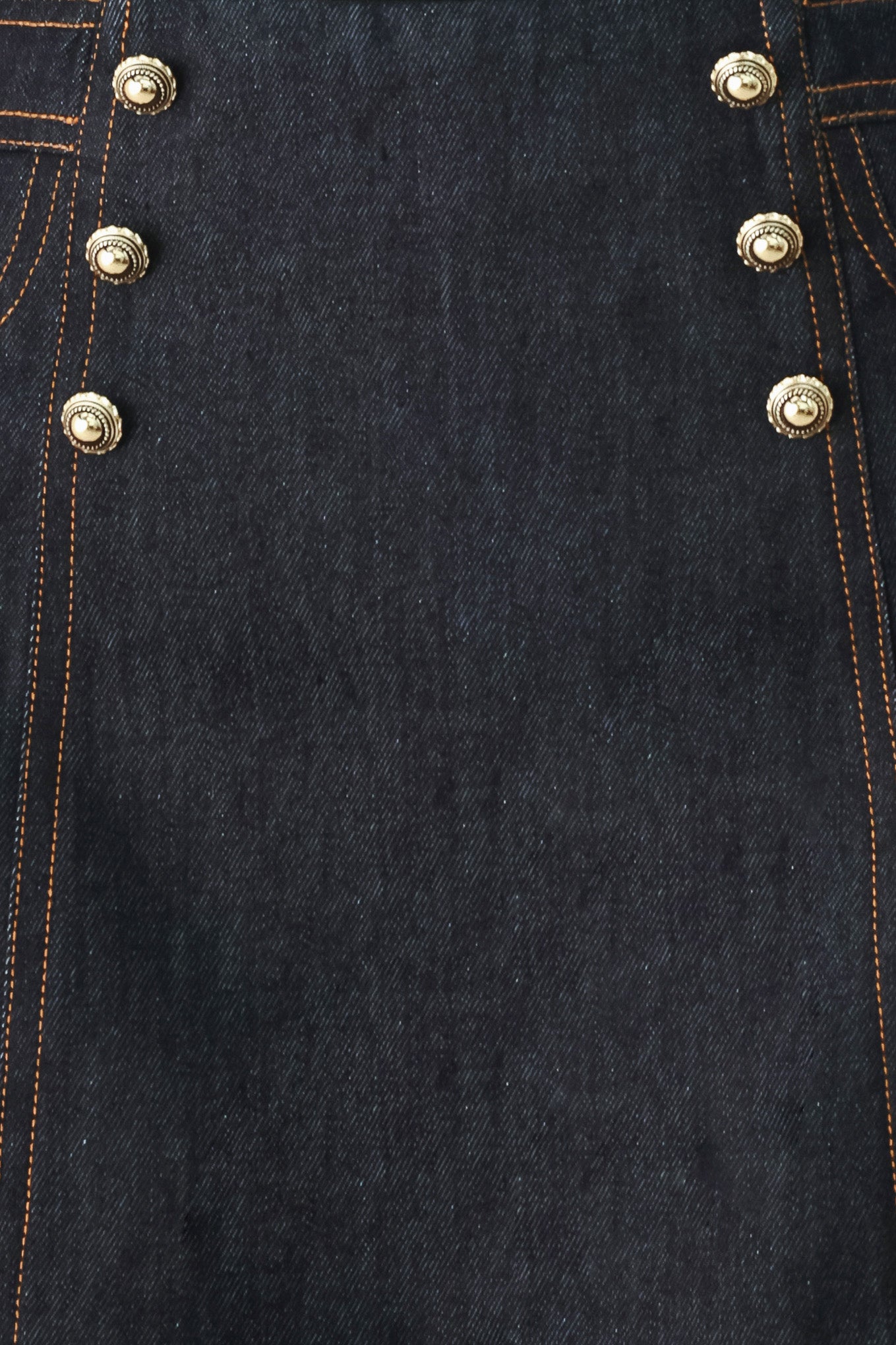 Woman wearing a dark lightweight denim skort with front button detail, pockets and back zipper closure | FREEMARKET