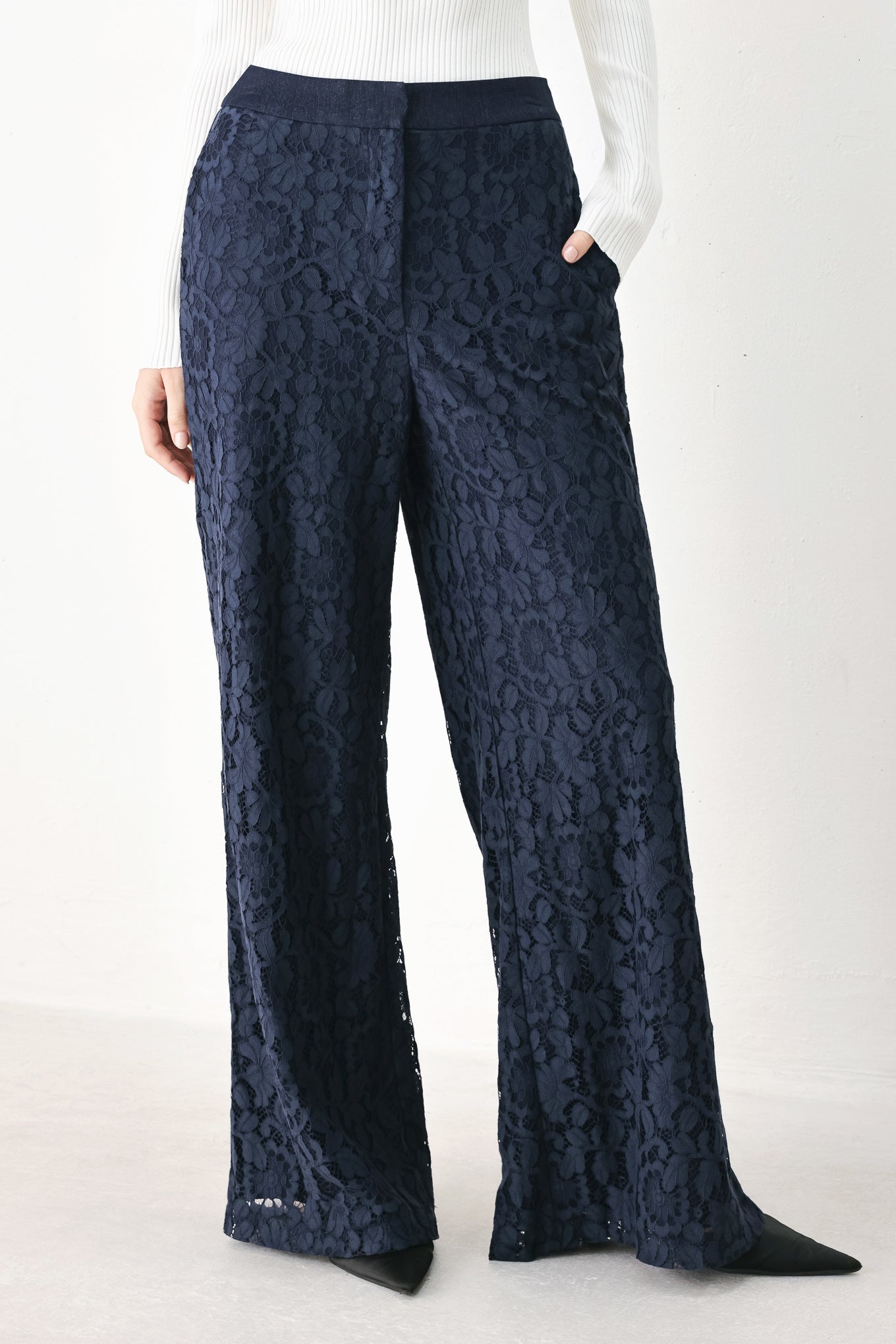 A model wearing dark navy lace wide-leg pants | FREEMARKET